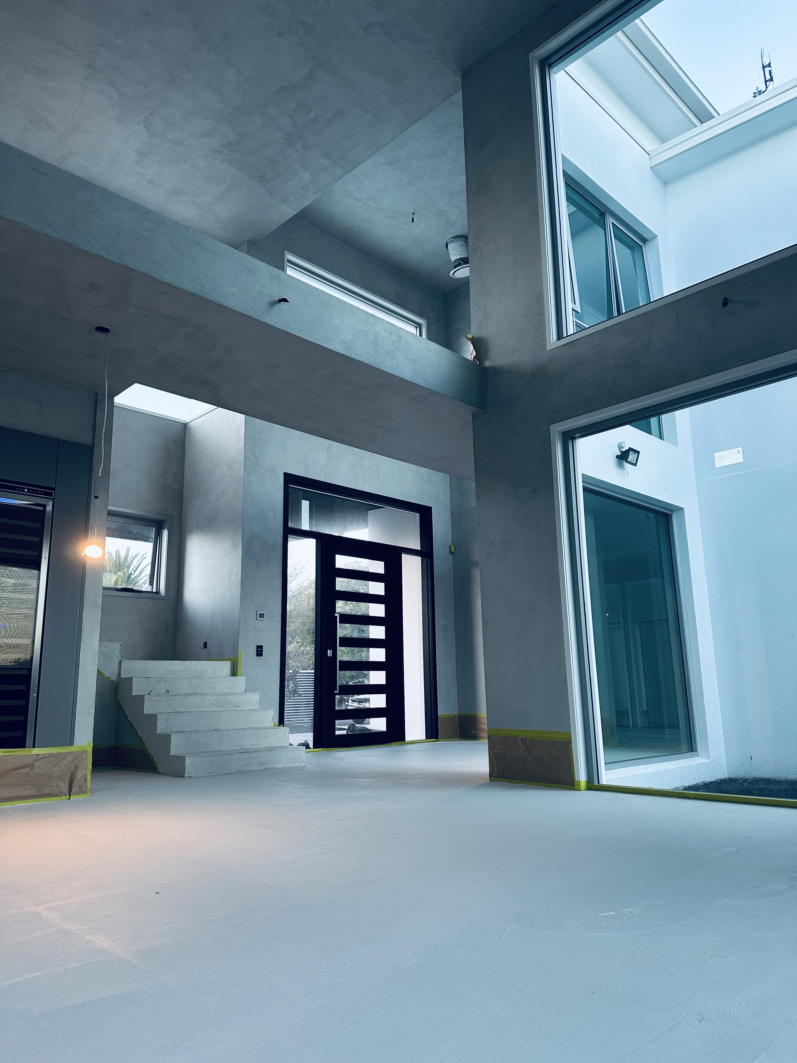Double-height interior during microcement construction