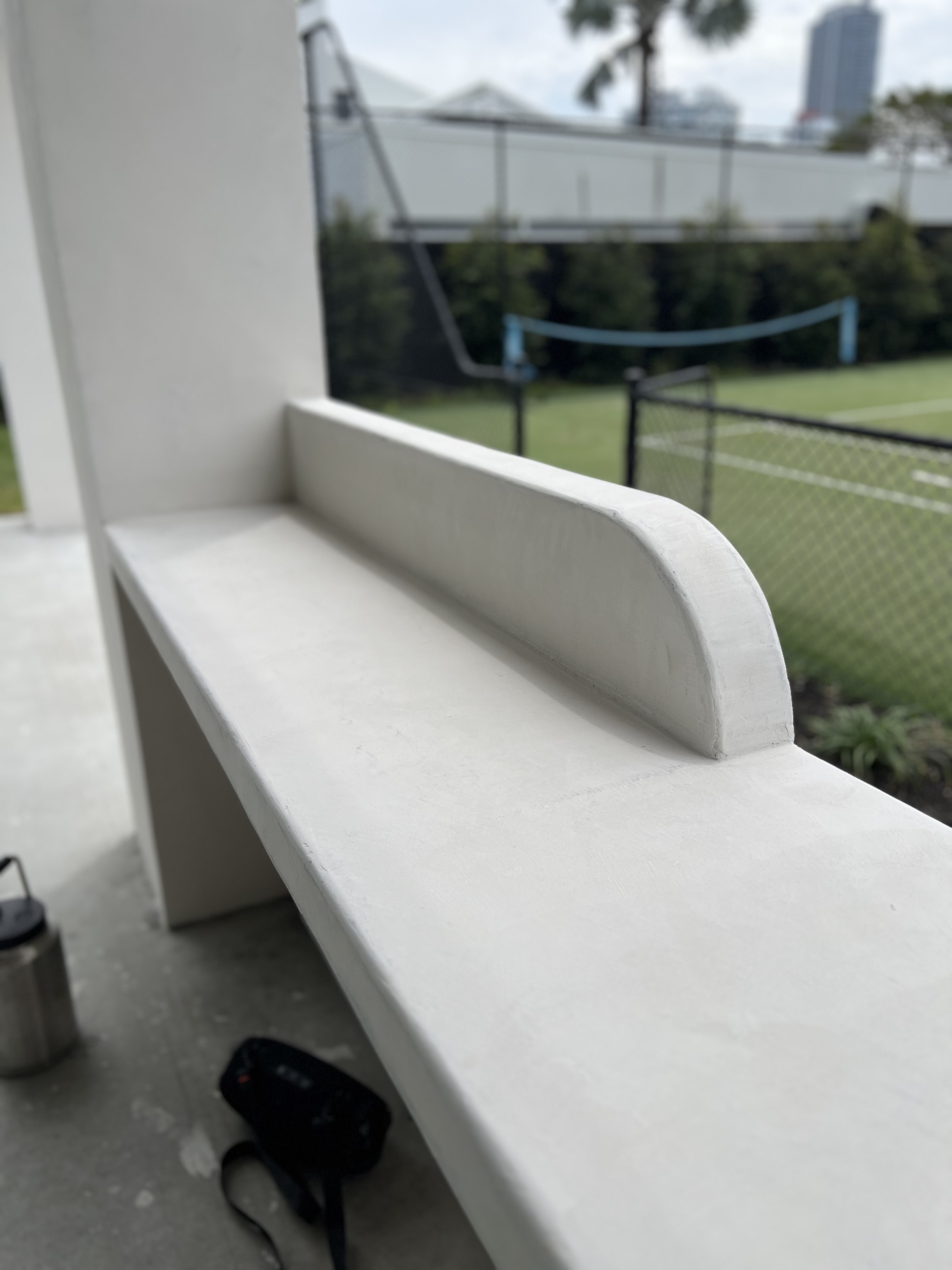 Close view of a smoothly finished curved microcement bench edge
