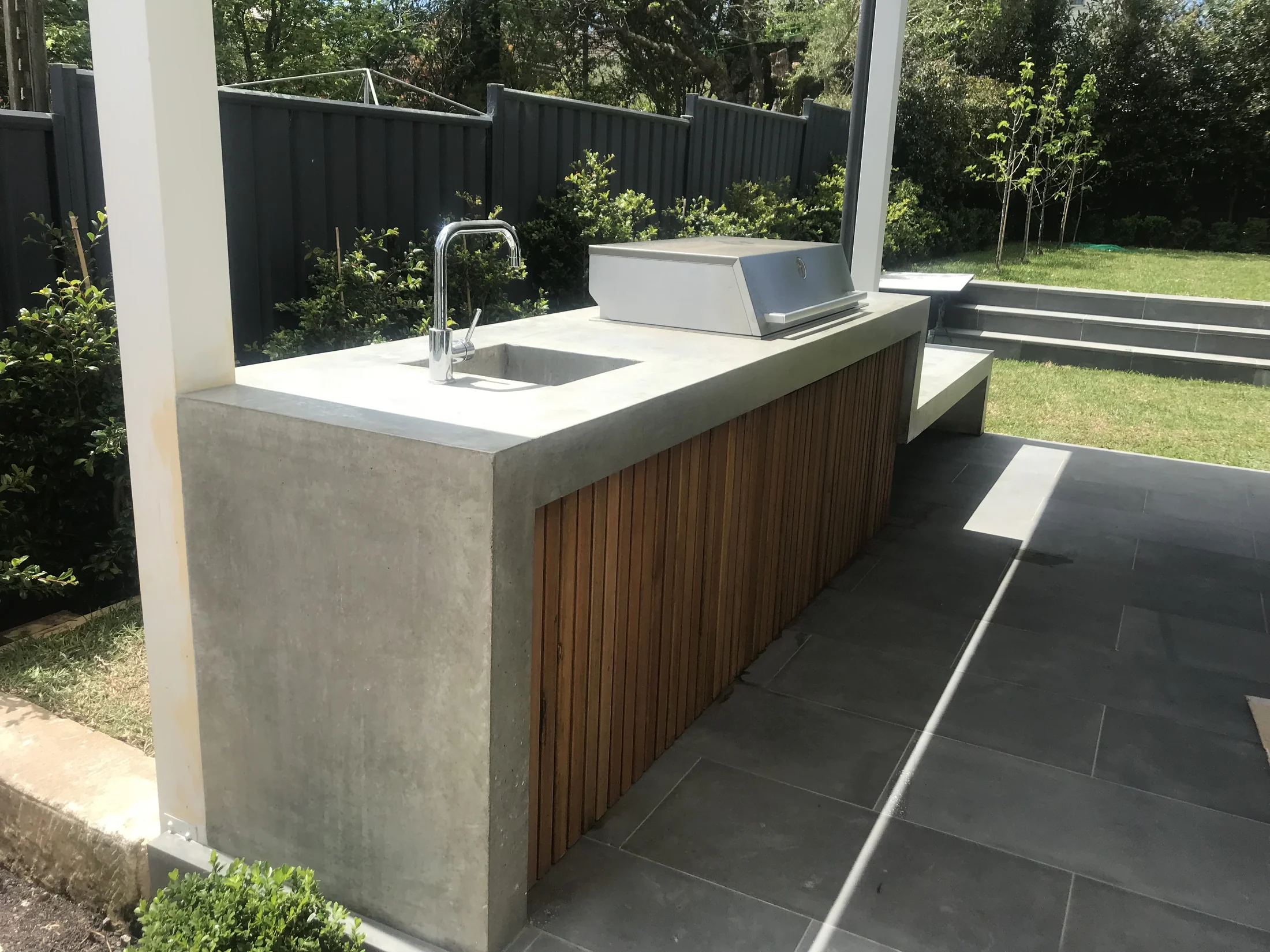 Completed concrete bar and benchtop in an outdoor setting