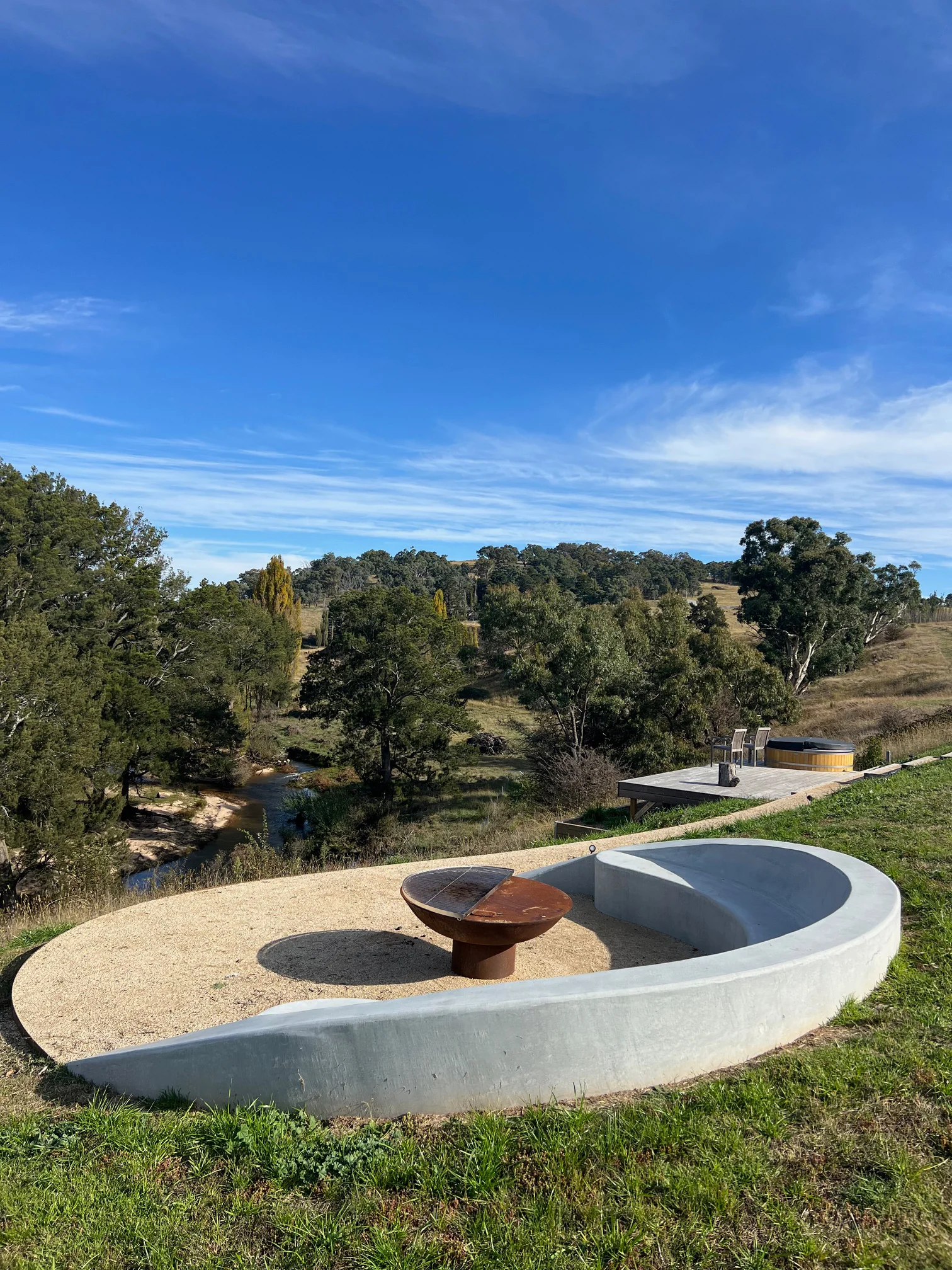 Completed curved concrete seating and firepit surround